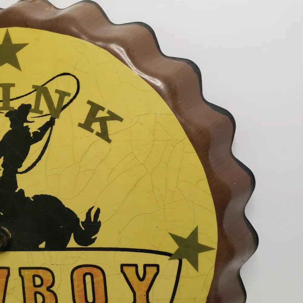 Metal Cowboy clock shaped like bottle cap. 191